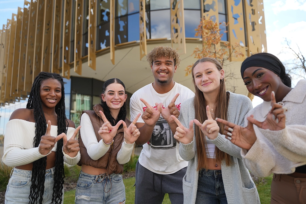 A small group of our students smiling having a'
